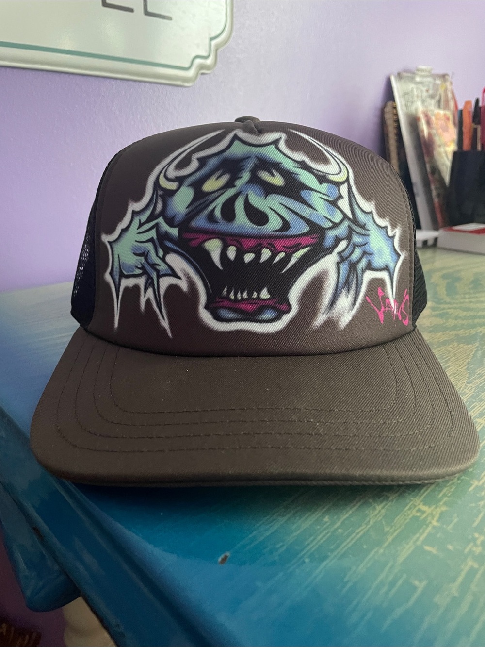Vans Wyman Trucker Graffiti Hat in the Coal Brown colorway